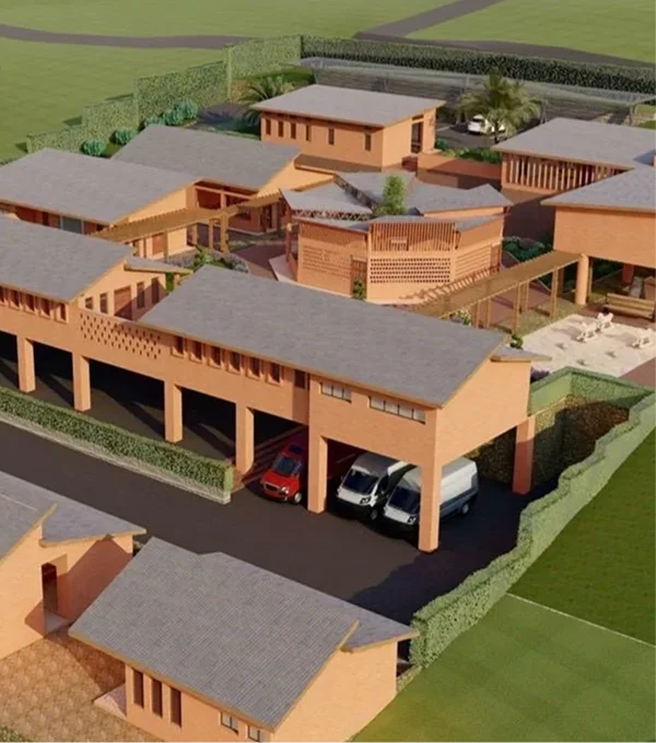 Aerial view of a modern residential complex with multiple buildings, parking spaces, and green landscaping.